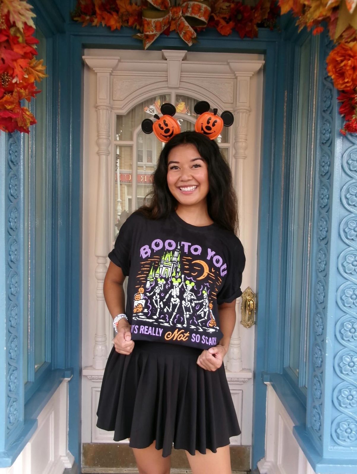 Women wearing a Not So Scary shirt, a MNSSHP Inspired t-shirt with dancing skeletons and magic castle located in Magic Kingdom located at Disney World and Disneyland. It is part of the Boo To You Parade.