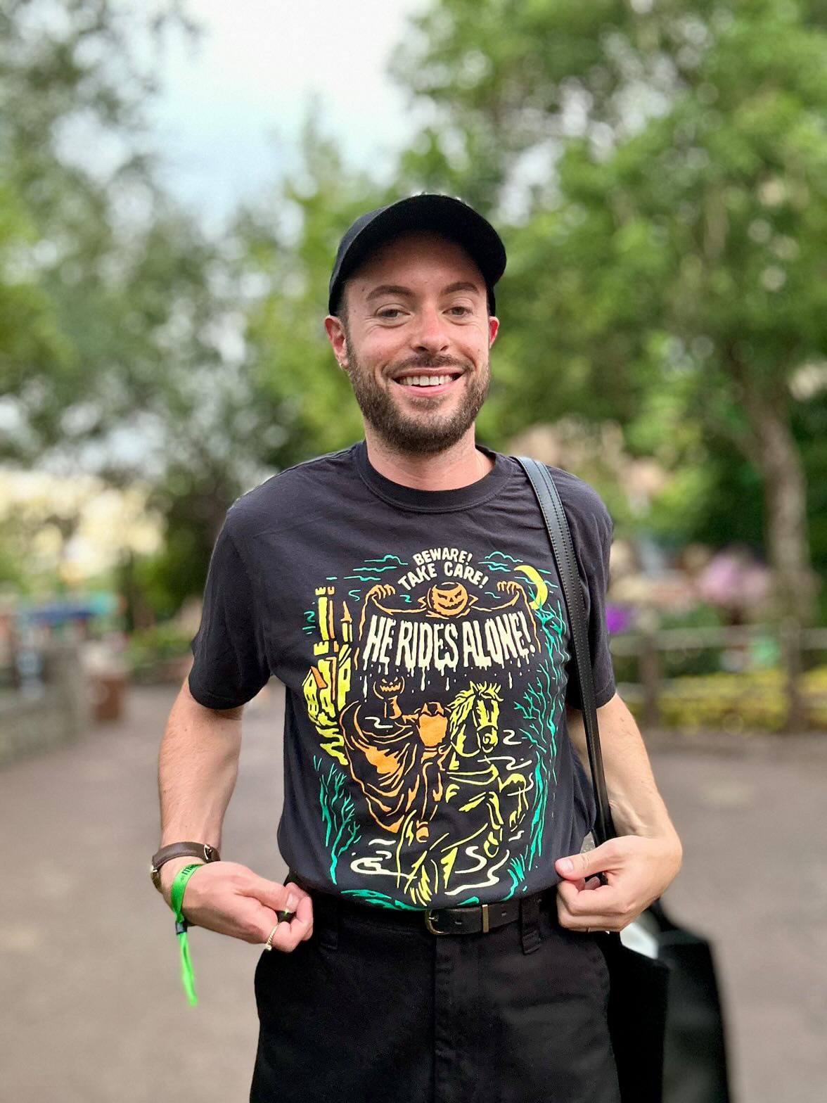 Man wearing a Headless shirt, a Headless Horseman inspired vintage t-shirt with pumpkins and magic castle design located in Magic Kingdom located at Disney World and Disneyland. Inspired by the Boo To You Parade at Mickeys Not So Scary Halloween Party.